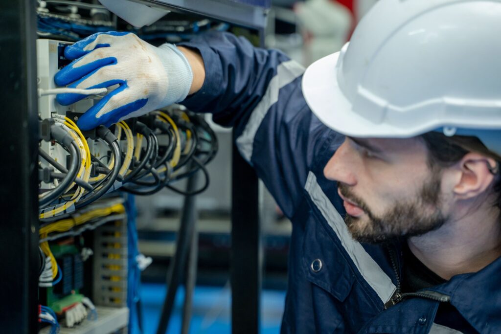 Electricity and electrical maintenance service,Electrical engineers test electrical installations and wiring on protective relays, measuring them with a multimeter.